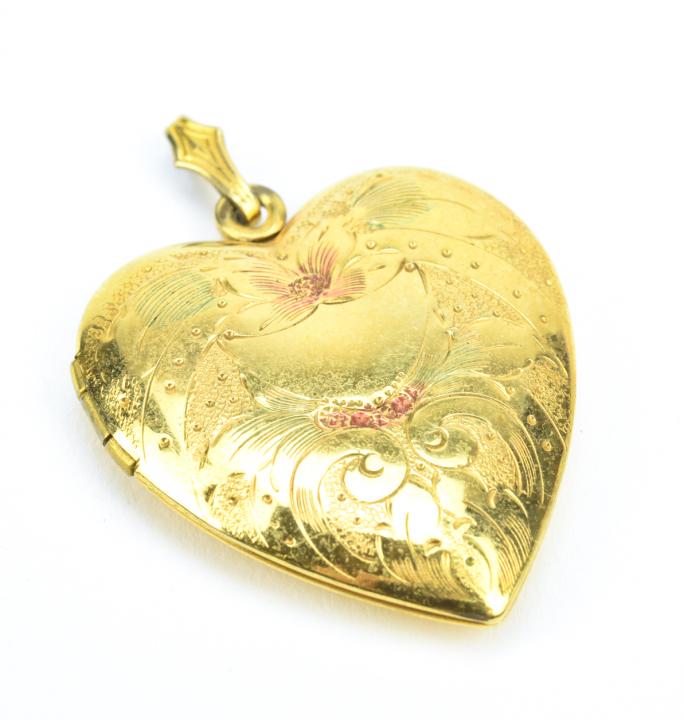 Antique Heart Form Gold Locket Pendant: Antique Heart Form Gold Locket Pendant. Yellow gold filled with chased scrollwork and floral motif on front. Measures 1.5 inches in length.