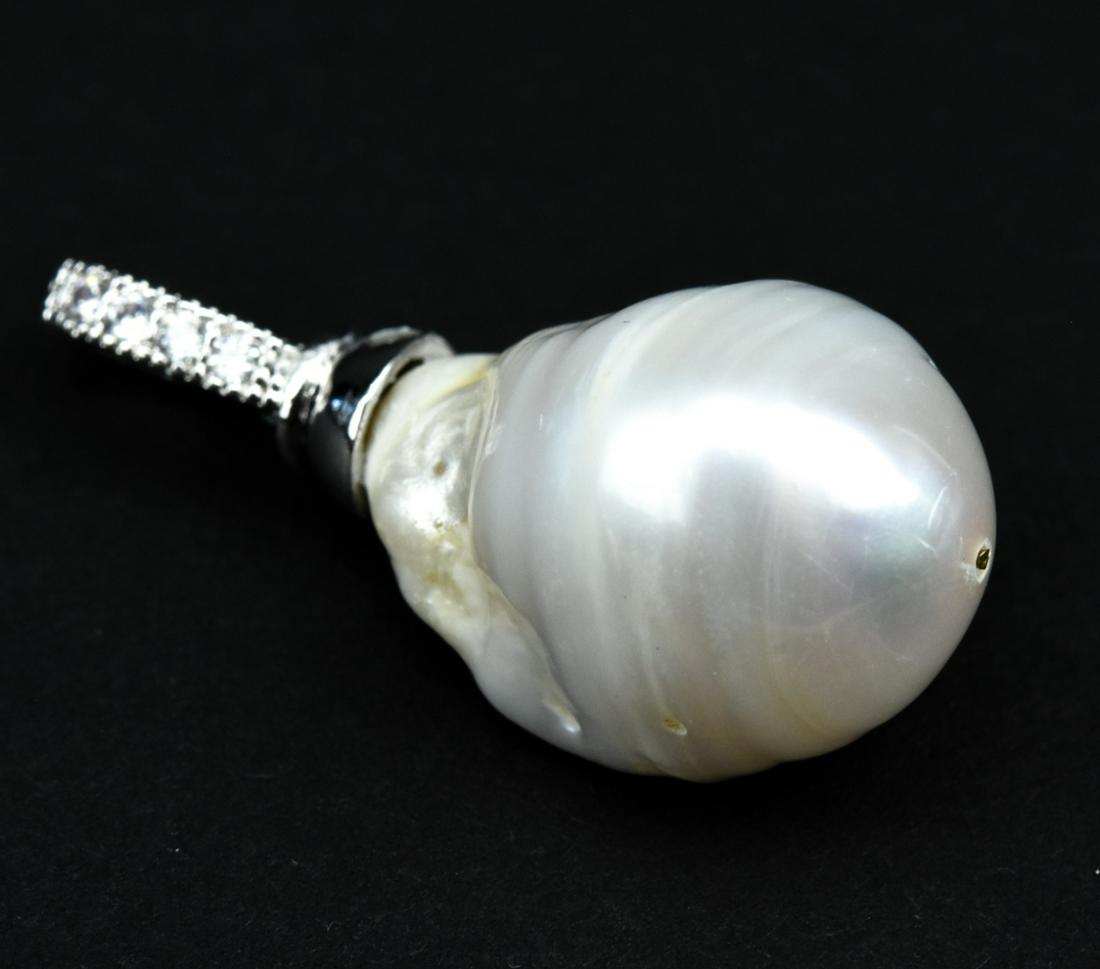 20MM Baroque Pearl Necklace Pendant: 20MM Baroque Pearl Necklace Pendant. High-luster, cultured baroque pearl mounted as a necklace pendant. Pearl is approximately 20mm in length. Necklace pendant measures 1.5 inches in length.