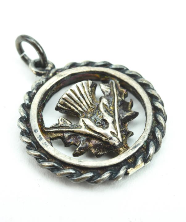 Vintage Scottish Sterling Silver Thistle Pendant: Vintage Scottish Sterling Silver Thistle Pendant. Measures 1 inch in length.