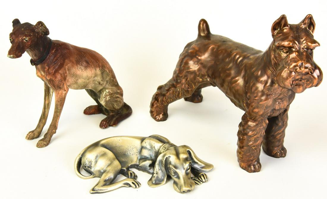 Collection Cast Iron & Copper Dog Figurines: Collection Cast Iron & Copper Dog Figurines. Includes Scottish Terrier, Greyhound, and Hound dog. Largest piece measures 7.25 inches high x 8 inches wide x 3 inches deep.