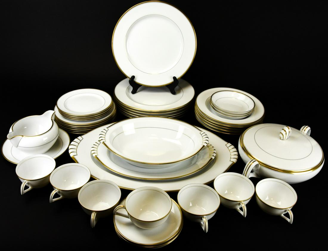Narumi Japan Bone China White Gold Rimmed Service: Narumi Japan Bone China White Gold Rimmed Service. Includes 6 dinner plates, 6 lunch plates, 5 soup bowls, 3 fruit dishes, 7 coffee cups, 5 saucers, 4 salad plates and 5 serving pieces.
