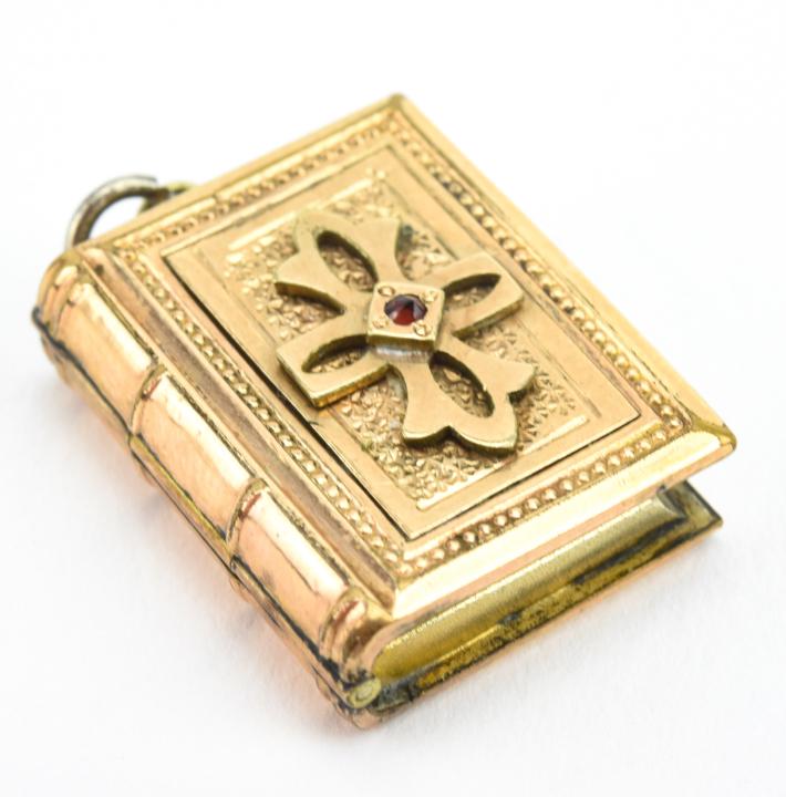 Antique 19th C Gold Book Form Locket w Garnet: Antique 19th C Gold Book Form Locket Necklace Pendant w Garnet. Front is set with a rose cut garnet. Measures just over 1 inch in length.
