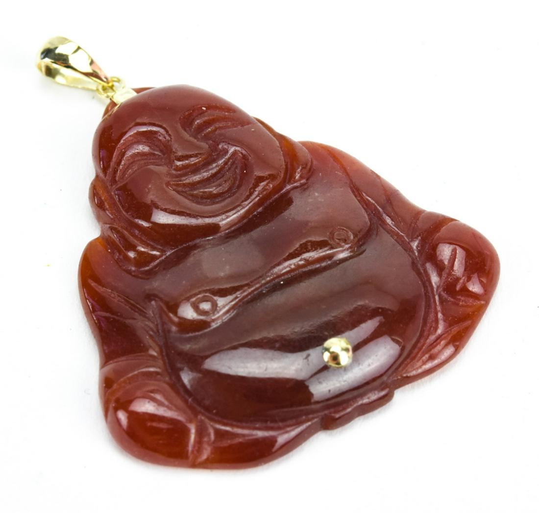 Estate 14kt Yellow Gold & Carnelian Chinese Buddha: Estate 14kt Yellow Gold & Carnelian Chinese Buddha Necklace Pendant. Hand carved carnelian Buddha with 14kt yellow gold fitting / bail. Measures approximately 2 inches in length.
