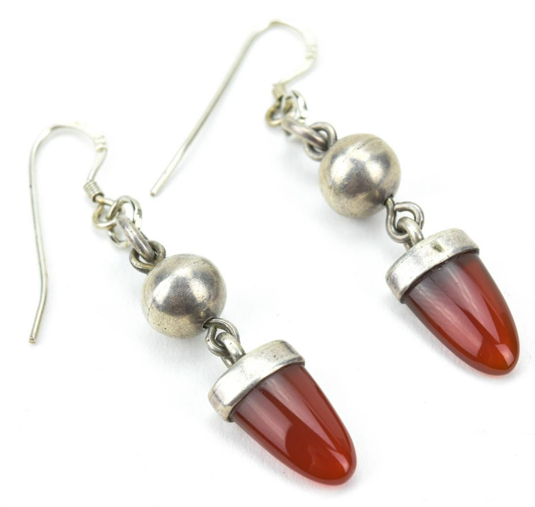 Pair Vintage Sterling Silver & Carnelian Earrings: Pair Vintage Sterling Silver & Carnelian Earrings. Each bezel set with a carved carnelian. Each measures 2 inches in length.