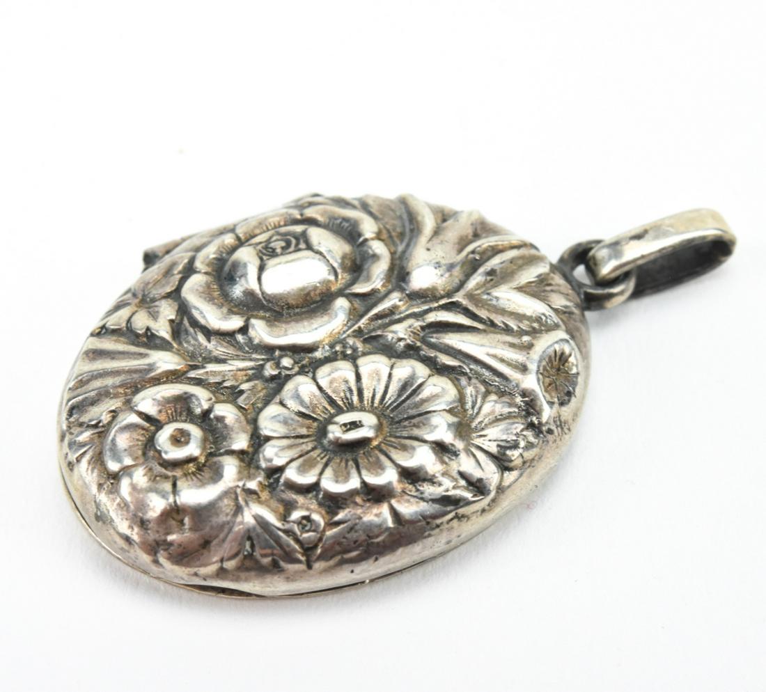 Antique Repousse Sterling Floral Motif Locket: Antique Repousse Sterling Floral Motif Locket Necklace Pendant. Measures 1.75 inches in length.