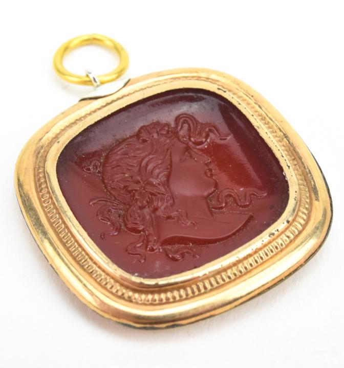 Antique C 1900 Carnelian Cameo Glass Pendant: Antique C 1900 Carnelian Cameo Glass Pendant. Gold filled frame set with a cameo glass panel resembling carnelian. Measures nearly 1.5 inches in length.