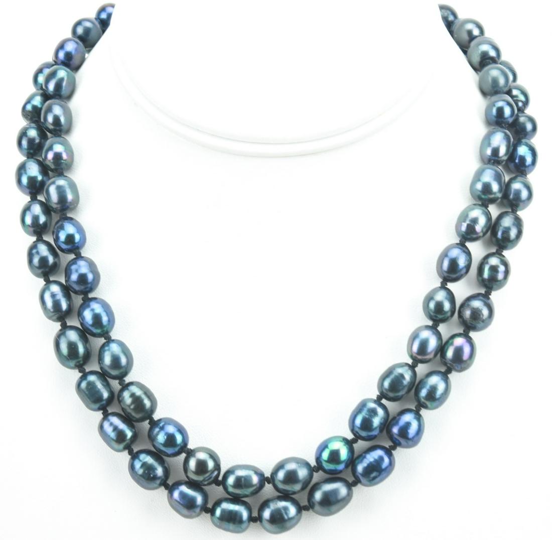 Pr Cultured Black Tahitian Baroque Pearl Necklaces: Pair of Cultured Black Tahitian Baroque Pearl Necklace Strands. Hand knotted on black silk thread with filigree clasps. The pearls are approximately 8 to 10 mm in length and have a high luster finish 