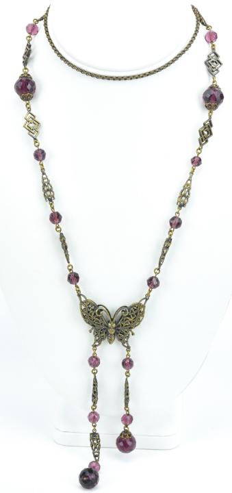 Antique Czech Art Glass Ormolu Butterfly Necklace: Antique Czech Art Glass Ormolu Butterfly Necklace. Having Amethyst art glass beads in various sizes with a butterfly pendant and tassel drops. Measures 31 inches in length plus tassel drops.