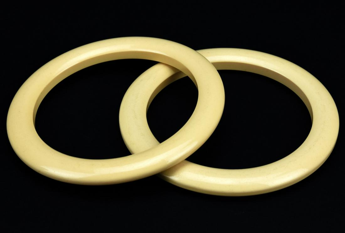 Pair of Bakelite Faux Bone Bangle Bracelets: Pair of Bakelite Faux Bone Bangle Bracelets. Bakelite or early plastic. Each measures just over 2.5 inches across interior opening.