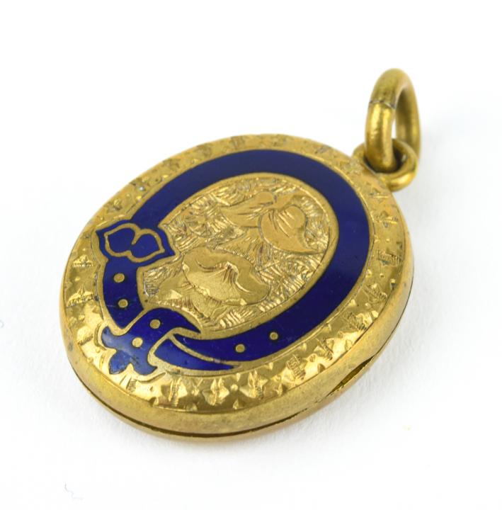 Antique 19th C Blue Enamel Buckle Locket Pendant: Antique 19th C Blue Enamel Buckle Locket Pendant. Gold filled locket necklace pendant with chased floral design and blue enamel buckle motif. Measures just over 1.5 inches in length.
