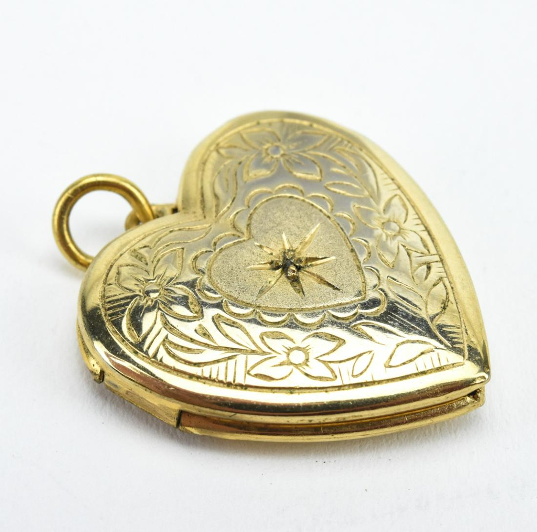 Estate Heart Form Locket w Diamond Accent Center: Estate Heart Form Locket w Diamond Accent Center. Locket necklace pendant w a diamond accent in the middle and floral motif design. Measures just over 1 inch in length.