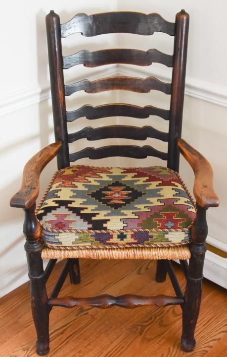 English Country Elmwood Ladder Back Armchair: English Country Elmwood Ladder Back Armchair with Carved Wings & Rush Seat. Includes custom Kilim seat cushion. Measures 43 inches high x 24 inches wide x 20 inches deep x 20 inches from floor to seat