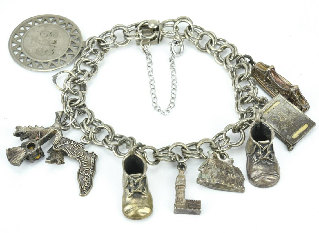 Vintage Charm Bracelet w Sterling Silver Charms: Vintage Charm Bracelet with Sterling Silver Charms. Charms include Scottish thistle, bridge, shoe, passport. Measures 7 inches in length, bracelet is also sterling.