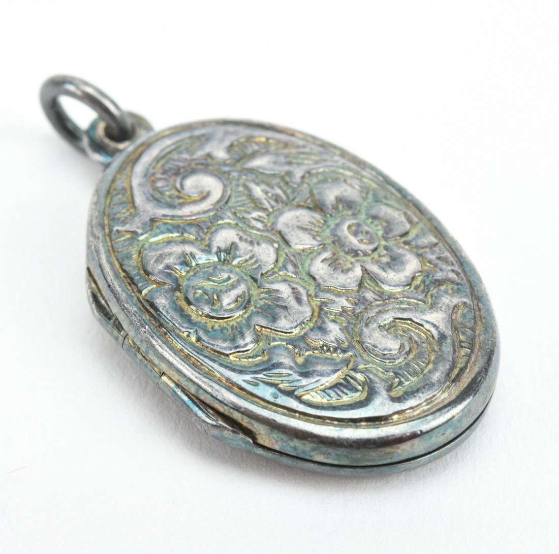 Estate Repousse Floral Motif Sterling Locket: Estate Repousse Floral Motif Sterling Silver Oval Form Locket. Measures just over 1.25 inches in length.