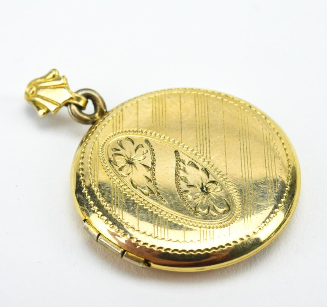 Antique Gold Floral Motif Locket Necklace Pendant: Antique Gold Floral Motif Locket Necklace Pendant. Yellow gold filled round locket necklace pendant with floral motif. Measures just over 1.25 inches in length.