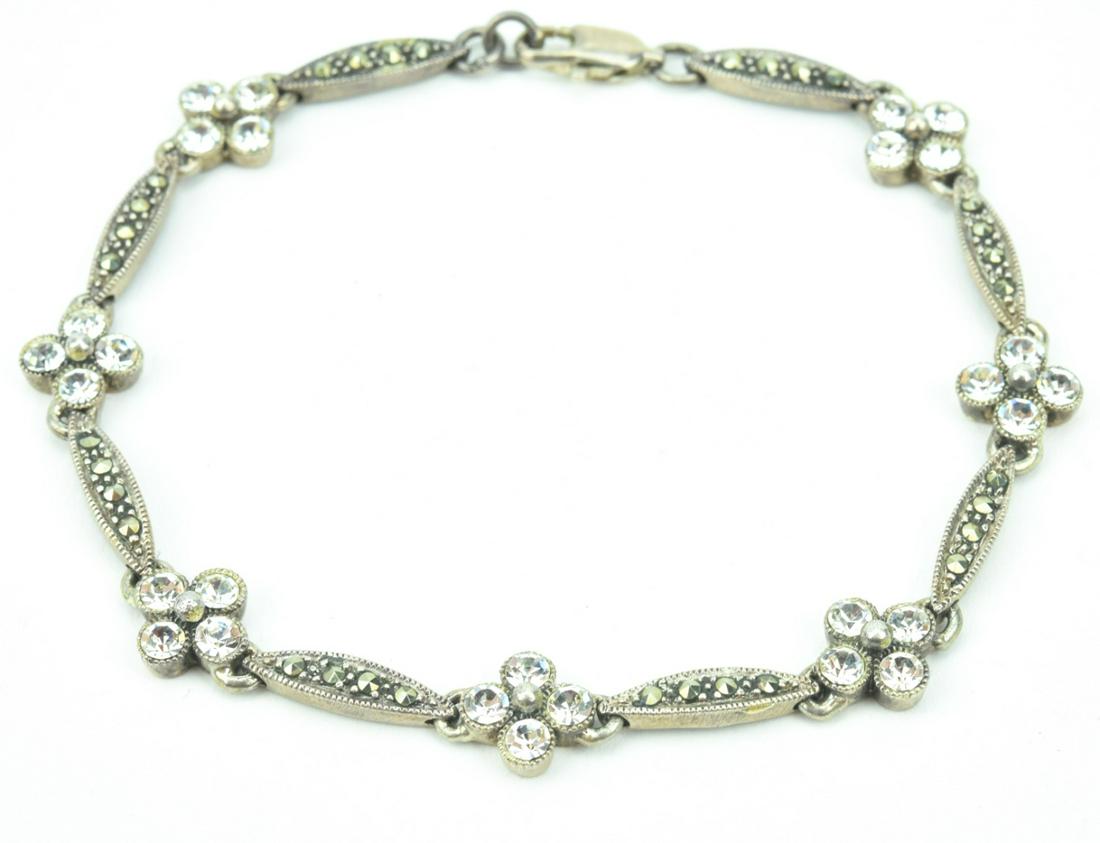 Sterling Silver & Marcasite Floral Motif Bracelet: Sterling Silver & Marcasite Floral Motif Bracelet. Set with rose-cut marcasites and clear rhinestone paste crystals. Measures 7.75 inches in length.