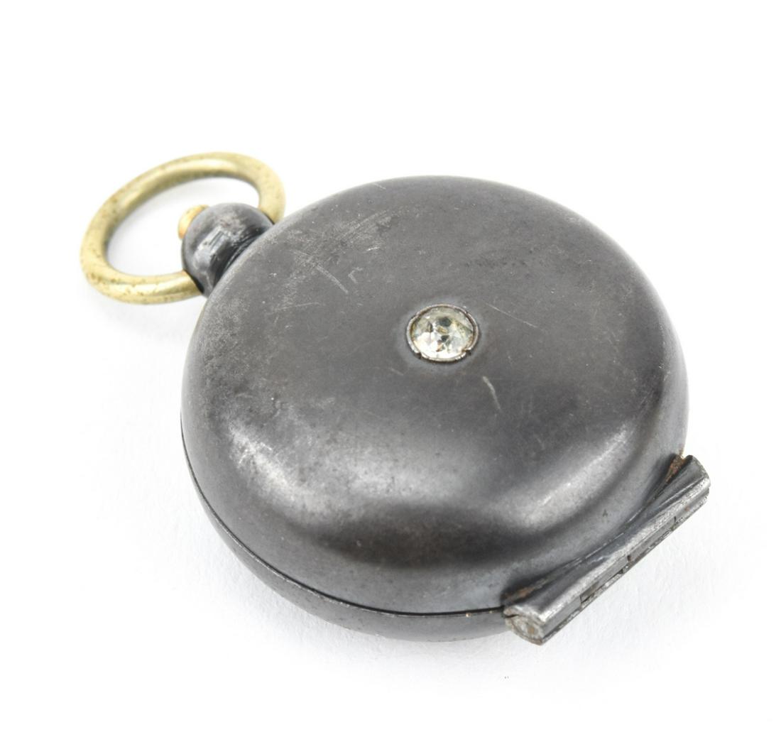 Antique 19th C Gun Metal Chatelaine Coin Locket: Antique 19th C Gun Metal Chatelaine Coin Holder Locket Pendant. Solitaire paste stone at center. Measures 2 inches in length.