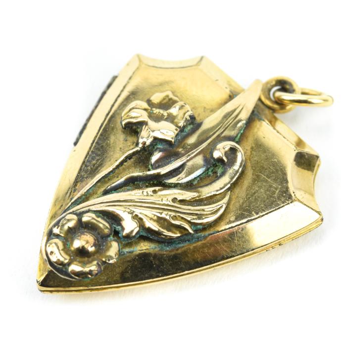 Estate Gold Filled Shield Form Locket w Flowers: Estate Gold Filled Shield Form Locket w Floral Motif. Measures 1.5 inches in length.