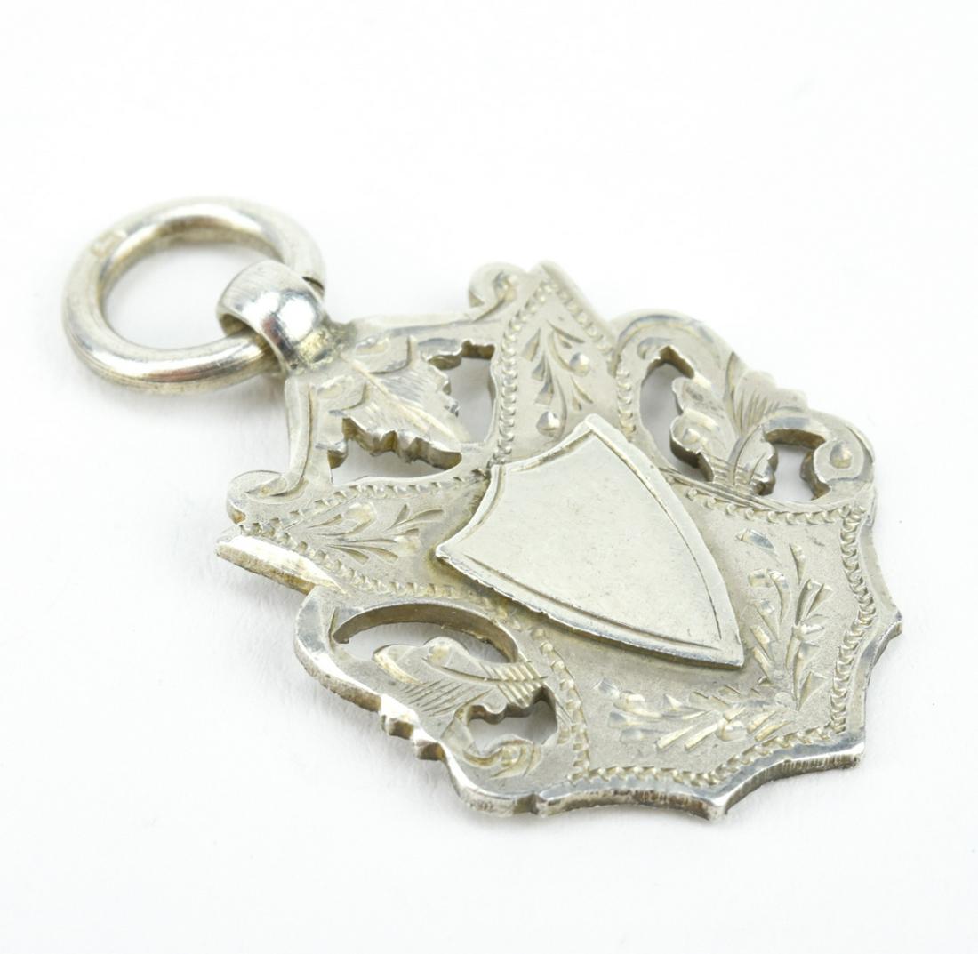 Antique English Sterling Coat of Arms Pendant: Antique English Sterling Silver Coat of Arms Shield Form Necklace Pendant / Fob / Medal. Hallmarked. Measures just over 1.5 inches in length.