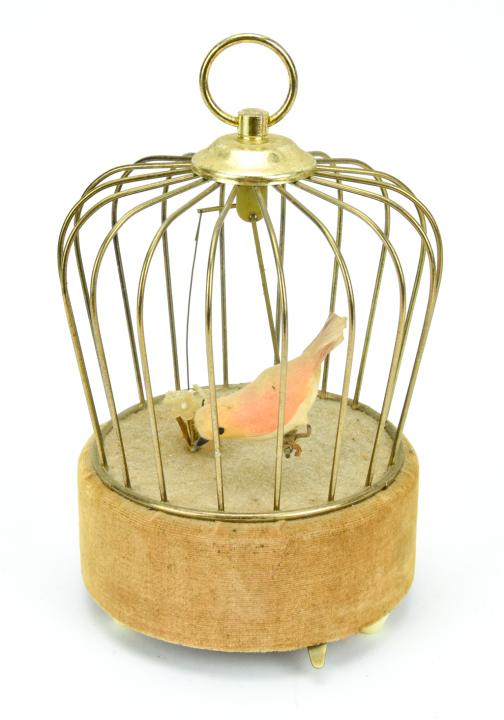 Automaton Music Box of a Bird in an Ormolu Cage: Automaton Music Box of a Bird in an Ormolu Cage. Works, music plays and the bird swings back and forth. Measures 7.5 inches in height.