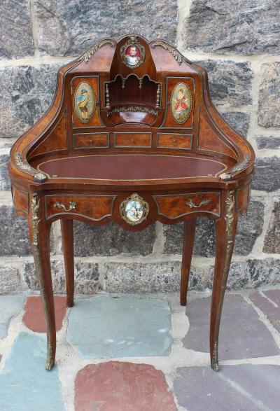 Antique Napoleonic Ormolu Desk Painted Portraits: Antique Napoleonic Ormolu Mounted, Burled Desk with Hand Painted Portrait Insets. Featuring an oval writing surface with red and gold tooled leather, shaped and molded back fitted with three small dov