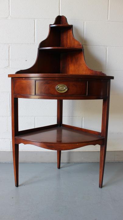Hepplewhite Style Carved Corner Etagere / Table: Hepplewhite Style Carved Corner Etagere / Table. Having two shelves surmounting a modified console table with single drawer and lower stretcher shelf. Measures 48 inches high x 26 inches wide x 17.5 i