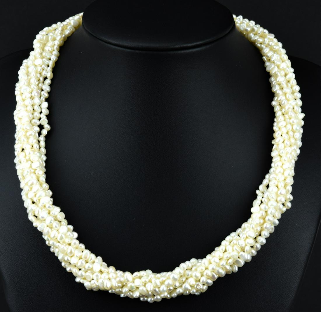 Estate 8 Strand Freshwater Baroque Pearl Necklace: Estate Eight Strand Freshwater Baroque Pearl Necklace. Having a bow form filigree clasp with eight strands of high luster baroque form pearls. Measures approximately 18.5 inches in length.
