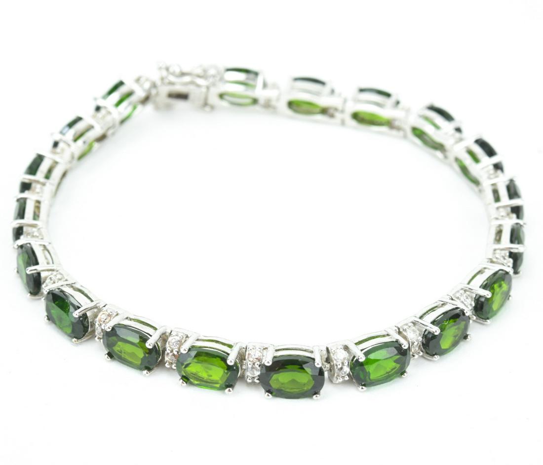Sterling Tourmaline & Topaz Tennis Bracelet: Sterling Silver Tourmaline & Topaz Tennis Bracelet. Hallmarked. Stones test as topaz and tourmaline on the Presidium. May be treated / enhanced. Measures 7 inches in length.