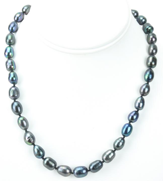 Baroque Tahitian Black Pearl Necklace Strand: Baroque Tahitian Black Pearl Necklace Strand. Hand knotted on black silk thread featuring baroque form pearls with high luster tones of black, gray and silver. Necklace measures 18.5 inches in length 