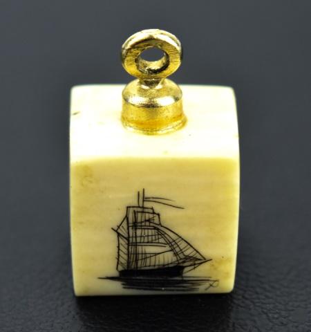 Estate New England Scrimshaw Pendant / Charm / Fob: Estate New England Scrimshaw Pendant / Charm / Fob. Carved and inked with scenes of ship, sail boat and light house. Measures 1/2 an inch in length.
