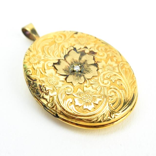 Diamond Set Floral Motif Locket Necklace Pendant: Diamond Set Floral Motif Locket Necklace Pendant. Measures just over 1.25 inches in length. Yellow gold filled.
