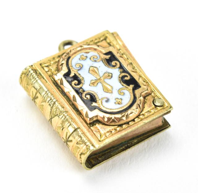 Antique 19th C Gold & Enamel Book Form Locket: Antique 19th C Gold & Enamel Book Form Locket Necklace Pendant. Slide open to reveal secondary book form panel with glass front locket. White and black enamel decorated. Gold filled / cased gold. Meas
