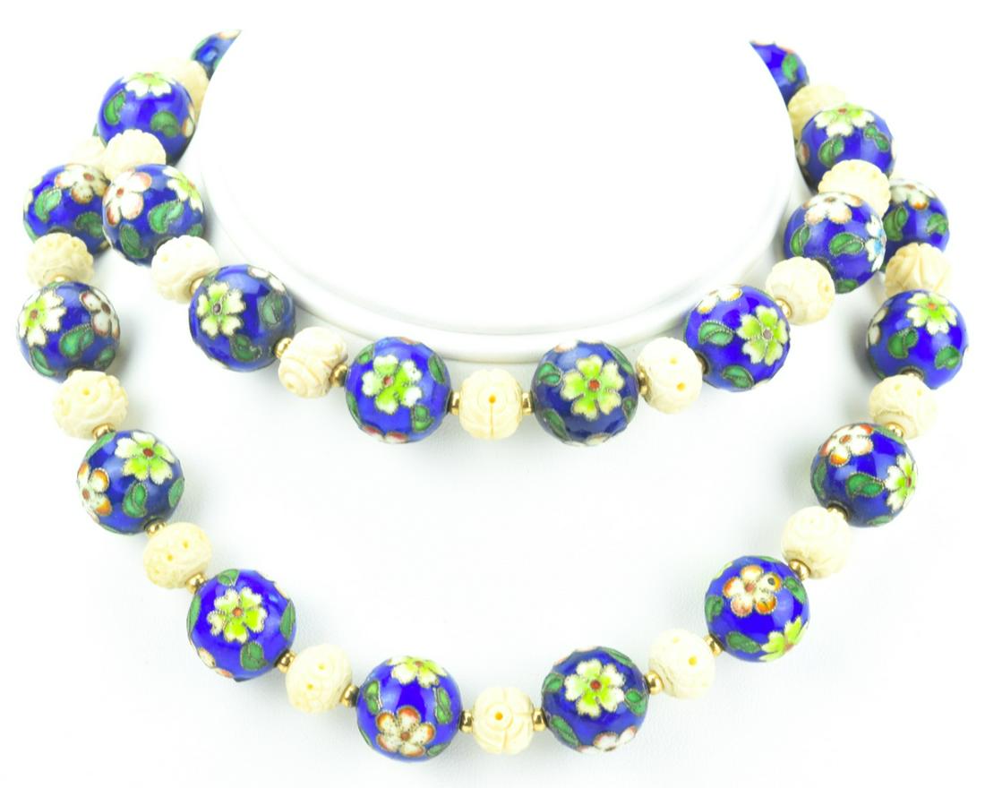 Estate Chinese Cloisonne Enamel & Bone Necklace: Estate Chinese Cloisonne Enamel & Bone Necklace. Set with floral motif enamel beads and hand carved bone beads. Measures 29 inches in length.