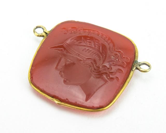 Antique 19th C Carnelian Glass Intaglio Pendant: Antique 19th C Carnelian Glass Intaglio Pendant. Greco Roman motif. Measures 1 inch in width.