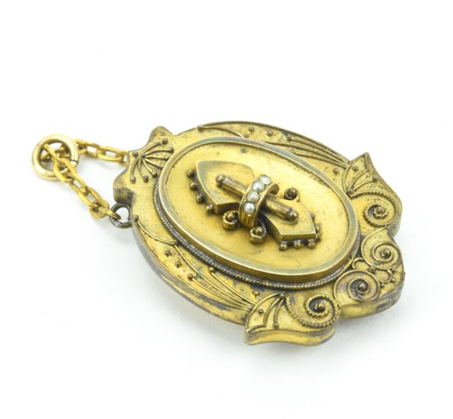 Antique 19th C Etruscan Revival Gold Pearl Locket: Antique 19th C Etruscan Revival Gold Pearl Locket Necklace Pendant. Gold filled with gold topped frame. Set with a band of natural seed pearls. The back opens. Measures just over 2 inches in length.