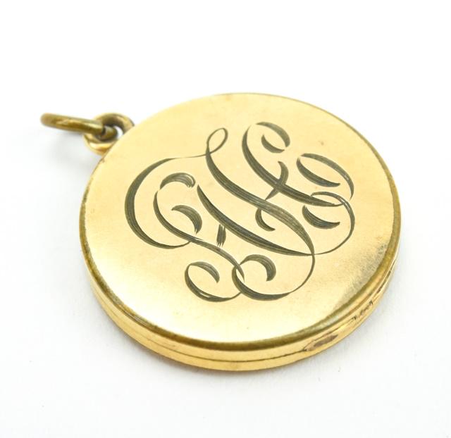 Antique 19th C Gold Monogram Locket Pendant: Antique 19th C Gold Monogram Locket Pendant. Yellow gold filled round locket necklace pendant with monogram. Measures 1.25 inches in length.