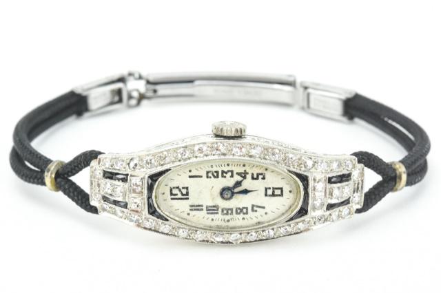 Antique Art Deco Era Platinum & Diamond Watch: Antique Art Deco Era Platinum & Diamond Watch. Set with approximately .44 of a carat of diamonds around the face in platinum case. Case measures just over 1.25 inches in length.