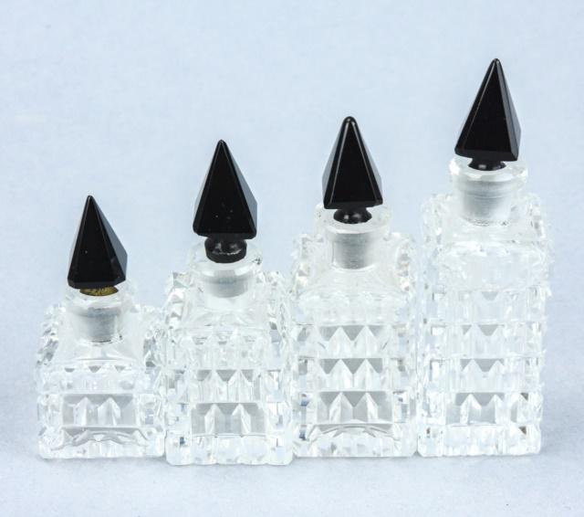 Antique Art Deco Graduated Size Perfume Bottles: Set of Antique Art Deco Graduated Size Perfume Bottles. Each with cut crystal body and basalt glass stopper. Tallest measures 3.25 inches in height.