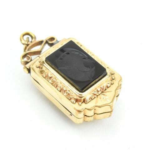 Antique 19th C Carved Onyx Intaglio Locket Pendant: Antique 19th C Carved Onyx Intaglio Locket Pendant. Gold filled frame hand carved onyx intaglio of a Greek or Roman soldier. Measures 1.5 inches in length.