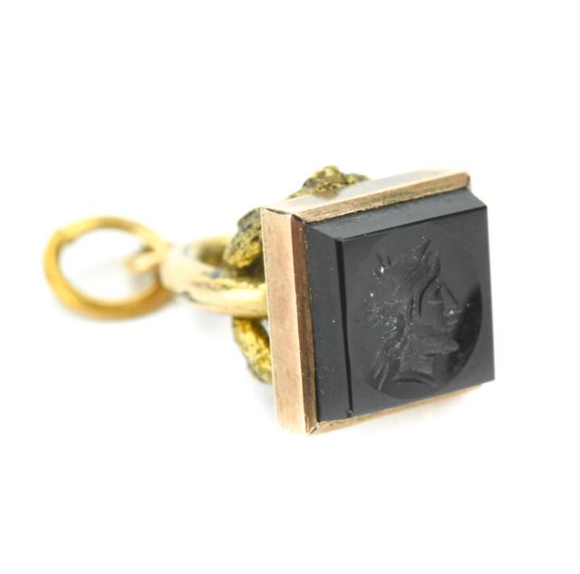 Antique Greco Roman Onyx Intaglio Charm or Fob: Antique 19th C Greco Roman Onyx Intaglio Charm or Fob. Measures .75 of an inch in length. Gold filled.