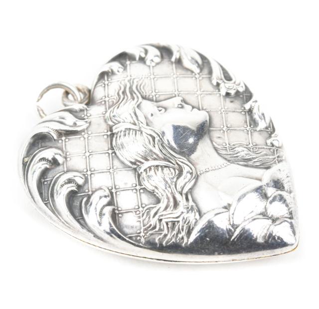 Estate Sterling Silver Art Nouveau Heart Locket: Estate Sterling Silver Art Nouveau Heart Locket Necklace Pendant. Portrait of a lady on front with scrollwork surround. Measures 1.5 inches in length.
