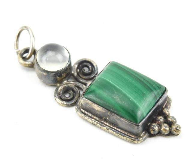 Sterling Silver Moonstone & Malachite Pendant: Sterling Silver Moonstone & Malachite Pendant. Having a round moonstone cabochon and a malachite panel. Measures 1.25 inches in length.
