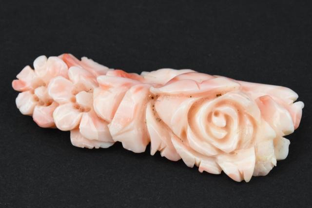 Estate Carved Angel Skin Coral Necklace Pendant: Estate Carved Angel Skin Coral Necklace Pendant. Hand carved natural coral floral motif necklace pendant. Measures 2.25 inches in length. Has holes for bails or string.