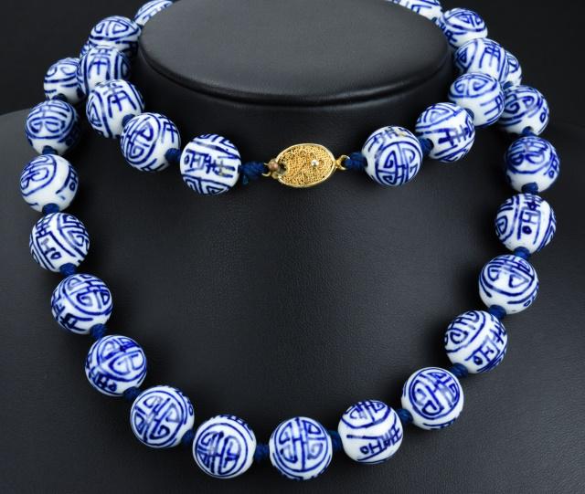 Estate Chinese Hand Painted Porcelain Necklace: Estate Chinese Hand Painted Porcelain Necklace. Hand knotted with hand painted blue and white porcelain beads and gilt metal Chinese filigree work clasp. Measures 26 inches in length.