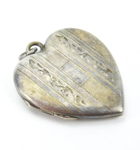 Antique Art Deco Sterling Silver Locket: Antique Art Deco Sterling Silver Locket Heart form sterling silver locket necklace pendant. Measures 1.25 inches in length.