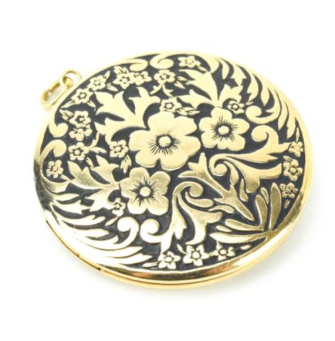 Estate Gold Filled & Black Enamel Locket Pendant: Estate Gold Filled & Black Enamel Locket Pendant. Round locket necklace pendant with floral motif in repossue gold filled with black enamel background. Hallmarked. Measures 1.5 inches in length.