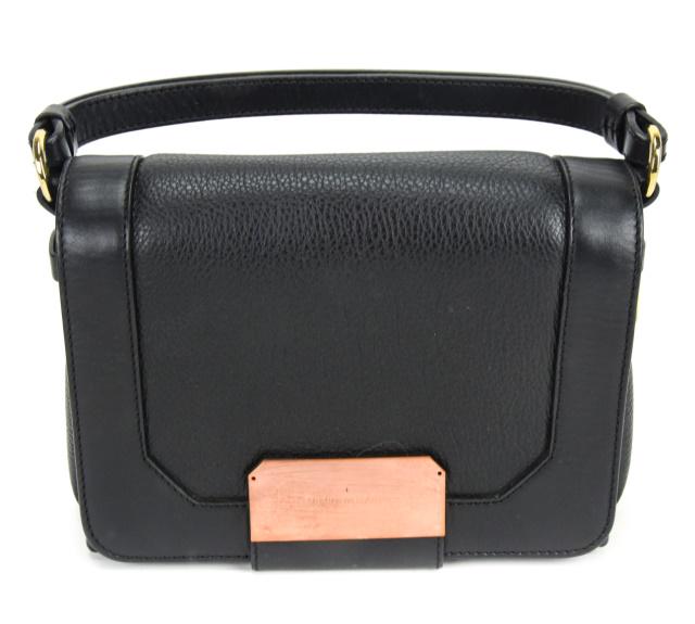 Stuart Weitzman Black Leather Eastsdaily Handbag: Stuart Weitzman Black Leather "Eastsdaily" Handbag / Cross Body Bag. With detachable shoulder strap. The lined interior includes three compartments, one zipper pocket and two slip pockets. Flap closur