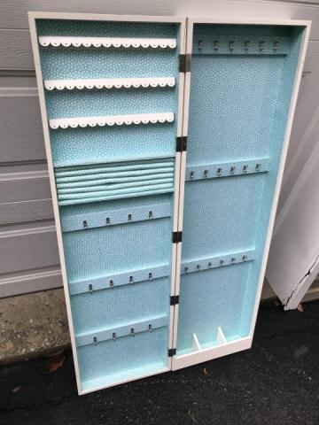 Mirrored Front Wall Mount Jewelry Storage Cabinet: Mirrored Front Wall Mount Jewelry Storage Cabinet. Measures 48 x 14 x 5.5 inches.