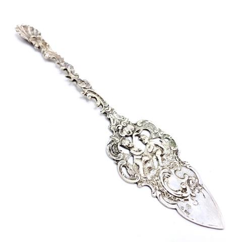 Silver Cherub Serving Utensil: Silver Cherub Serving Utensil. Approximately 7.75 inches long. Hallmarked WWH 800. 36 grams.