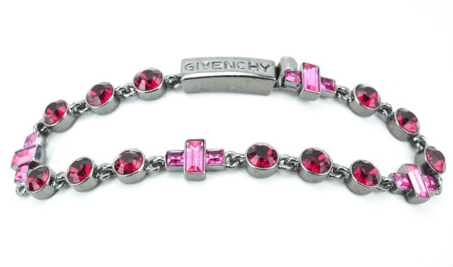 Givenchy French Costume Jewelry Bracelet: Givenchy French Costume Jewelry Bracelet. Gun metal tone with ruby paste and pink sapphire paste crystals. Signed. Measures just under 7.5 inches in length.